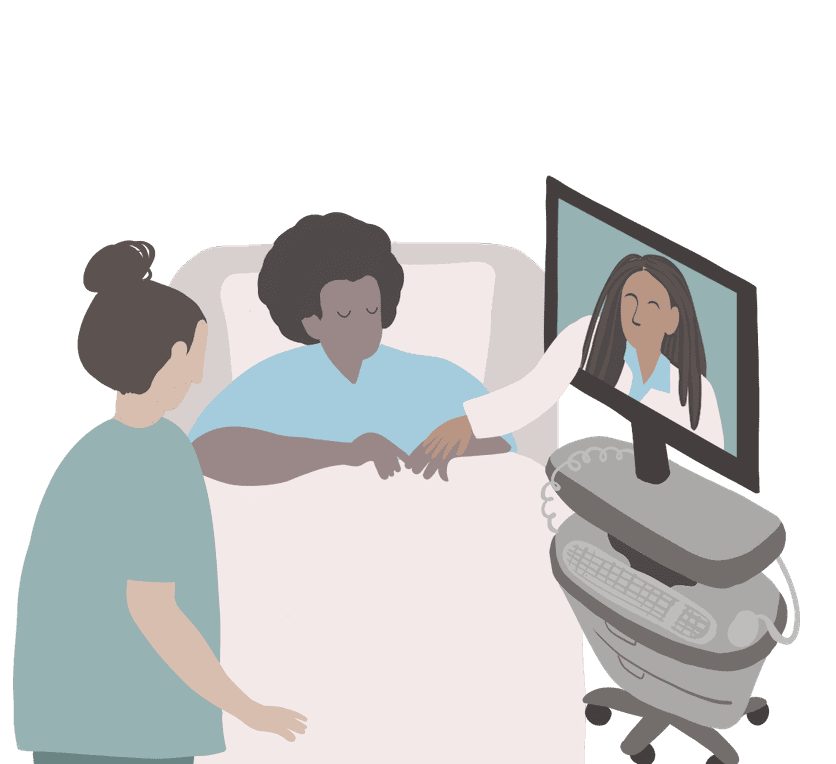 Two healthcare workers comfort a patient lying in a hospital bed next to a specialized telehealth station.